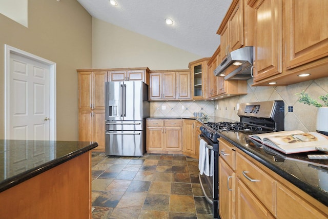 kitchen featuring appliances with stainless steel finishes, tasteful backsplash, high vaulted ceiling, and dark stone counters