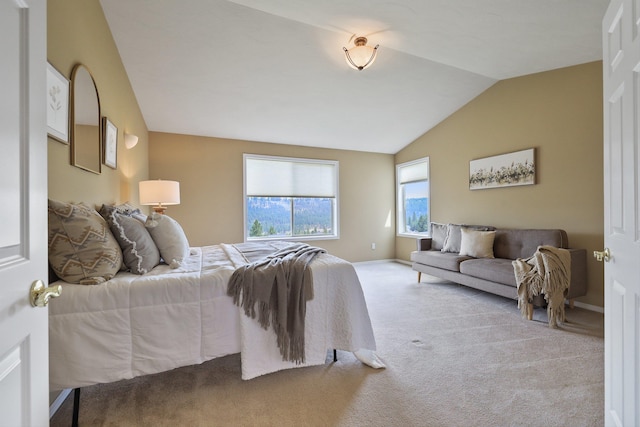 carpeted bedroom featuring lofted ceiling