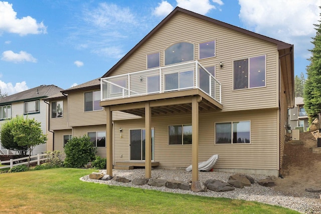 back of property featuring a lawn and a balcony