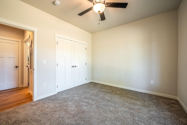 unfurnished bedroom featuring a closet, dark carpet, and ceiling fan