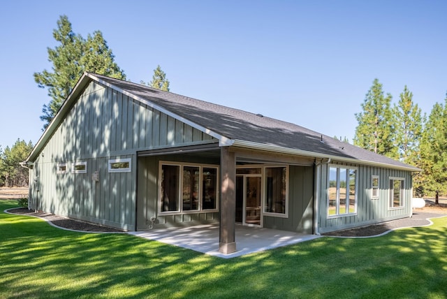 rear view of property with a yard and a patio