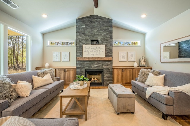 living room featuring lofted ceiling, light wood-type flooring, and a fireplace