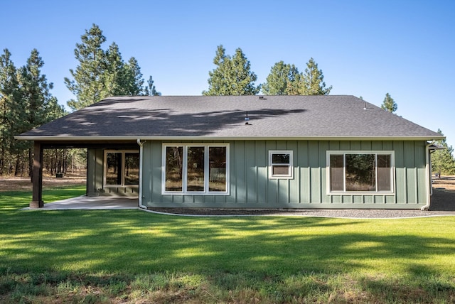 rear view of house featuring a yard and a patio area