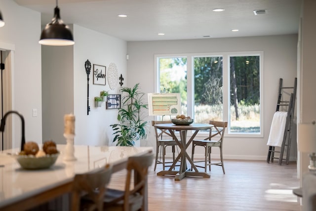 dining space with light hardwood / wood-style floors