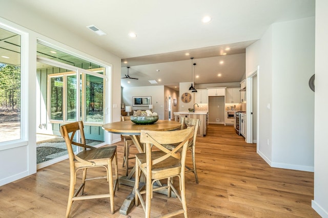 dining area featuring light hardwood / wood-style floors, plenty of natural light, and sink