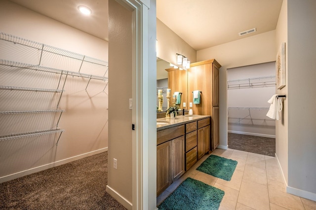 bathroom with tile patterned flooring and vanity