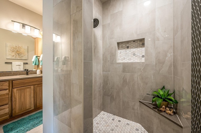 bathroom featuring vanity and tiled shower