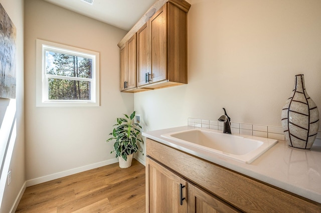 washroom with sink and light wood-type flooring