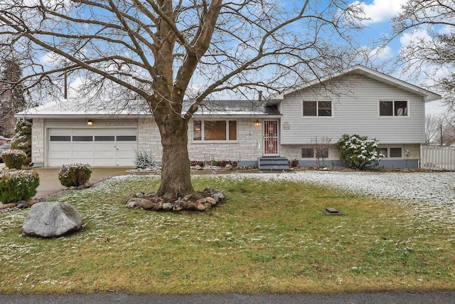 split level home with a garage and a front yard