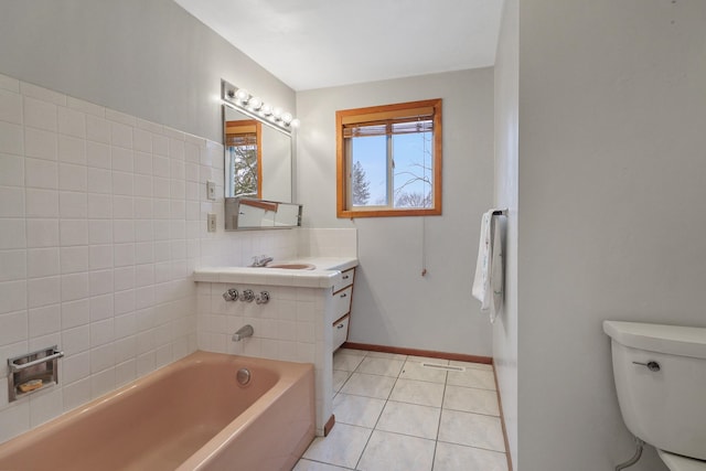 bathroom featuring toilet, a tub, and tile patterned floors