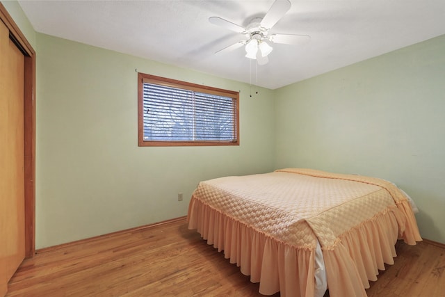 bedroom with a closet, ceiling fan, and light hardwood / wood-style floors