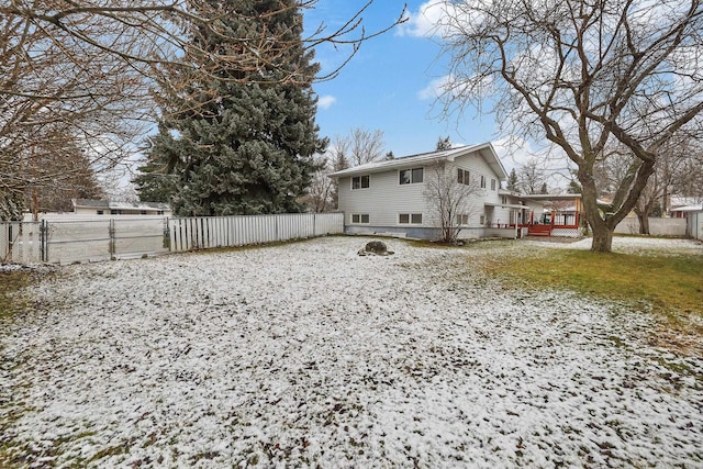 view of snow covered back of property