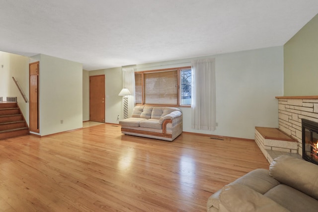 living room featuring a fireplace and light hardwood / wood-style flooring