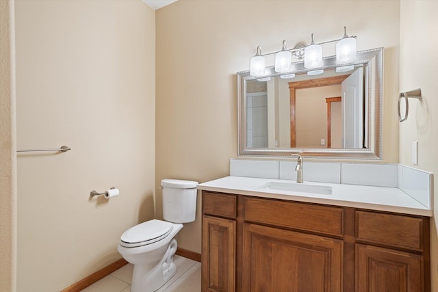 bathroom with tile patterned flooring, vanity, and toilet