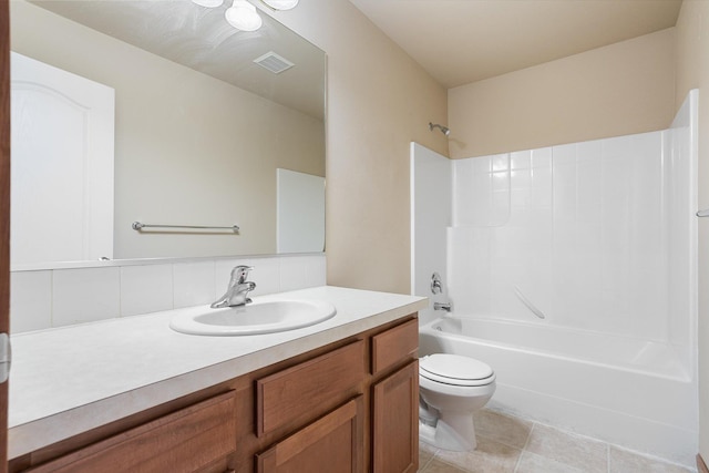 full bathroom with washtub / shower combination, tasteful backsplash, tile patterned floors, toilet, and vanity