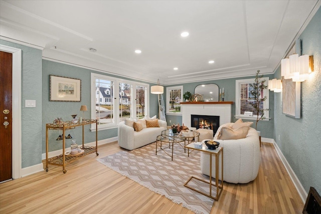 living room with light hardwood / wood-style floors and a brick fireplace