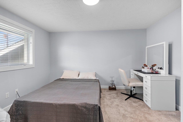 carpeted bedroom featuring a textured ceiling