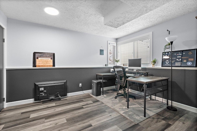 home office featuring a textured ceiling and hardwood / wood-style flooring