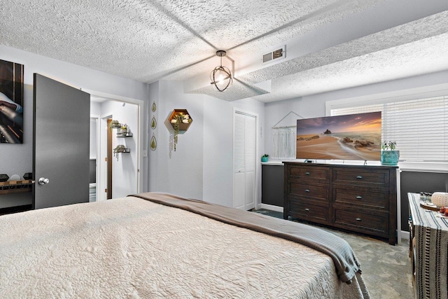 carpeted bedroom with a closet and a textured ceiling