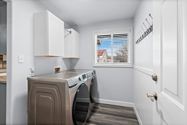 laundry room featuring cabinets, independent washer and dryer, and dark hardwood / wood-style flooring