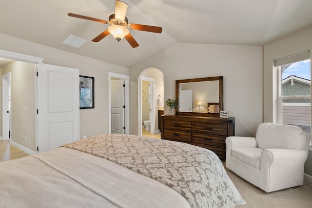 carpeted bedroom featuring ceiling fan, lofted ceiling, and connected bathroom