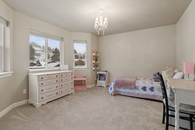 carpeted bedroom with a textured ceiling and a notable chandelier