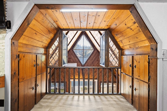 interior space featuring wood walls, wood ceiling, and vaulted ceiling