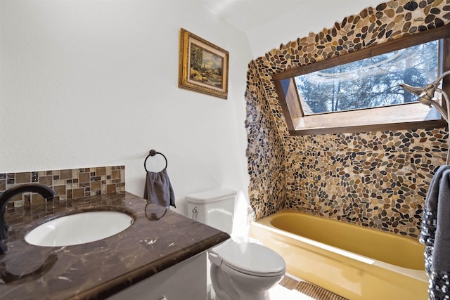 bathroom featuring vanity, toilet, and a bath