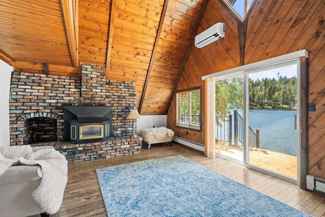 living room featuring beamed ceiling, a wall unit AC, a wood stove, and wood ceiling