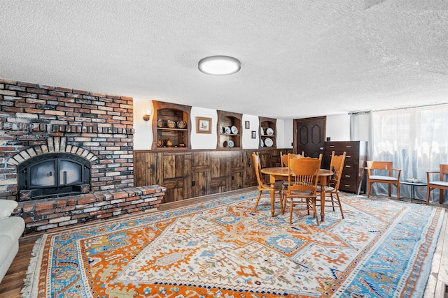 dining room featuring hardwood / wood-style floors and a textured ceiling