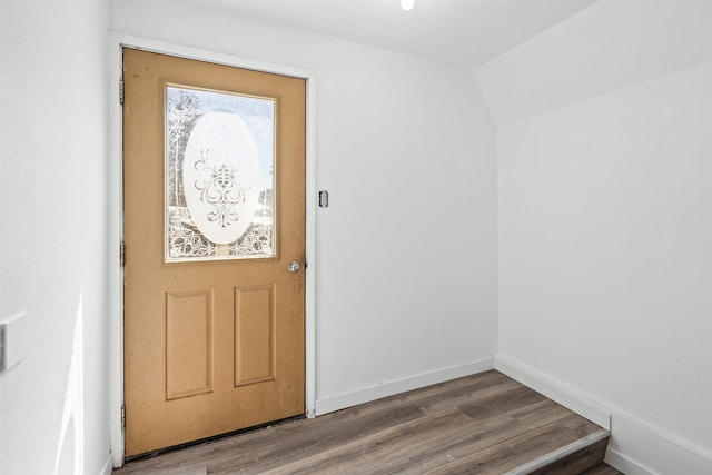 doorway to outside featuring hardwood / wood-style floors and vaulted ceiling