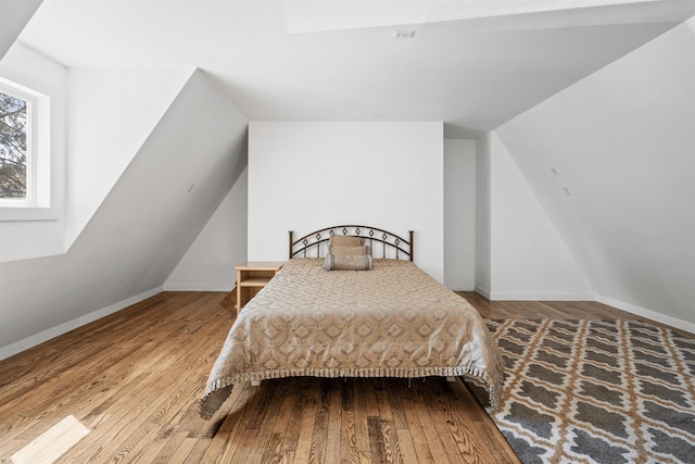 bedroom with hardwood / wood-style flooring