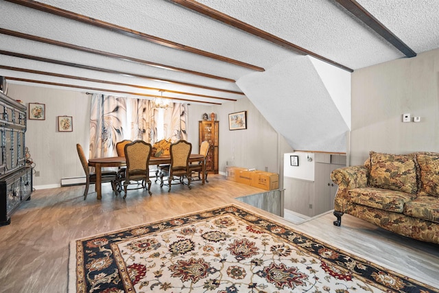 living room with beamed ceiling, wood-type flooring, a textured ceiling, and a wealth of natural light