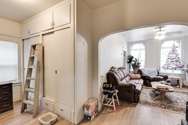 living room featuring ceiling fan and light hardwood / wood-style flooring