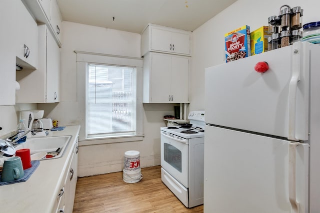 kitchen featuring white appliances, light hardwood / wood-style floors, white cabinetry, and sink