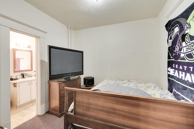 carpeted bedroom featuring ensuite bath