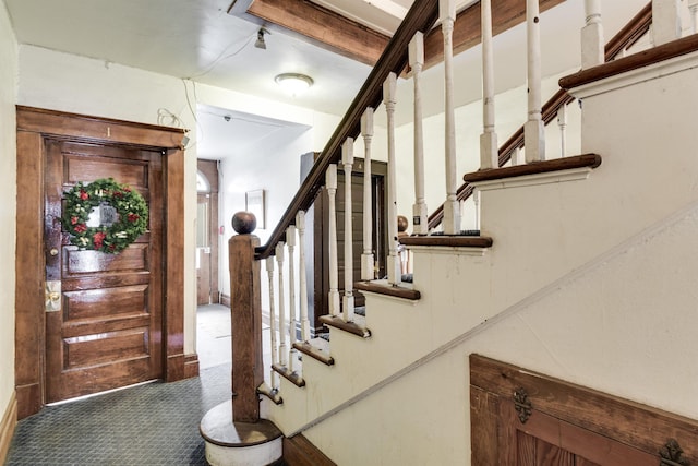 entryway featuring dark colored carpet