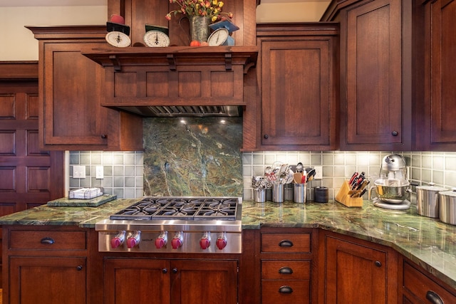 kitchen featuring backsplash, light stone counters, and stainless steel gas stovetop