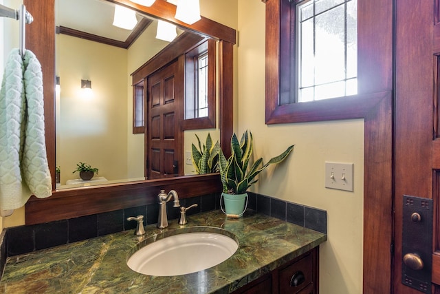 bathroom featuring vanity and ornamental molding