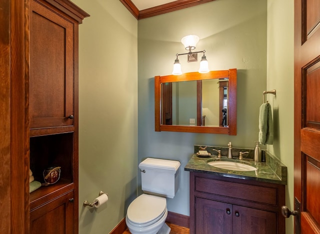 bathroom featuring vanity, toilet, and ornamental molding