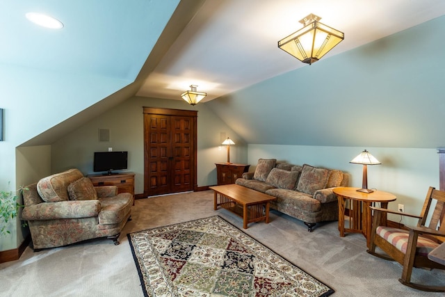 carpeted living room featuring lofted ceiling