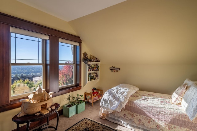 bedroom featuring multiple windows, carpet floors, and lofted ceiling