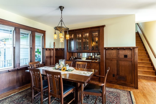 dining space with a notable chandelier and light hardwood / wood-style floors