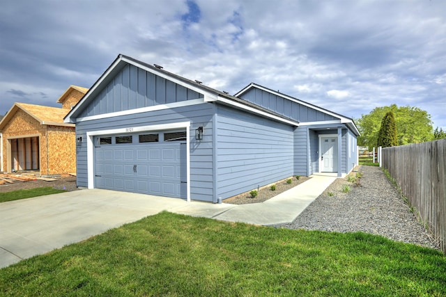 view of front facade with fence, an attached garage, concrete driveway, and board and batten siding