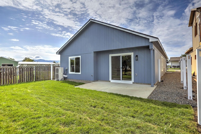 back of house featuring a patio, fence, a lawn, and ac unit