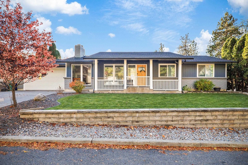 view of front of property with a porch and a front yard