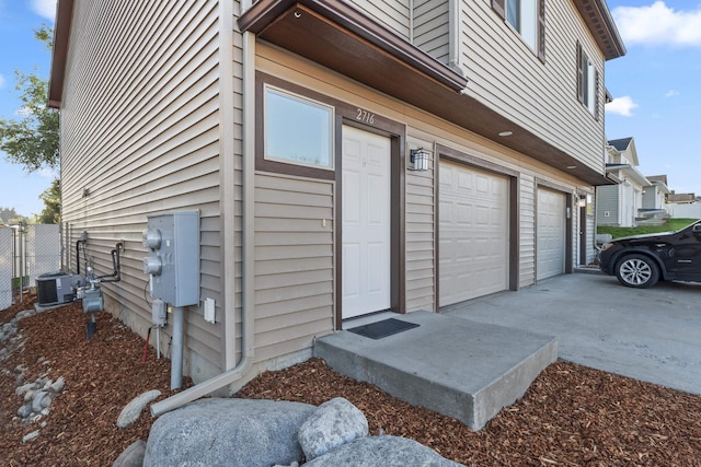 exterior space with a garage and central air condition unit