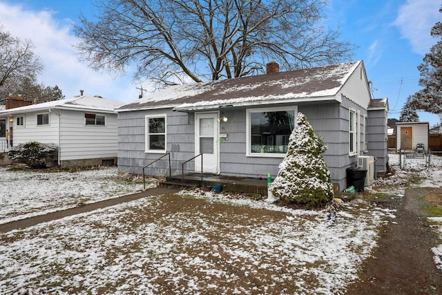 bungalow-style house featuring central AC unit