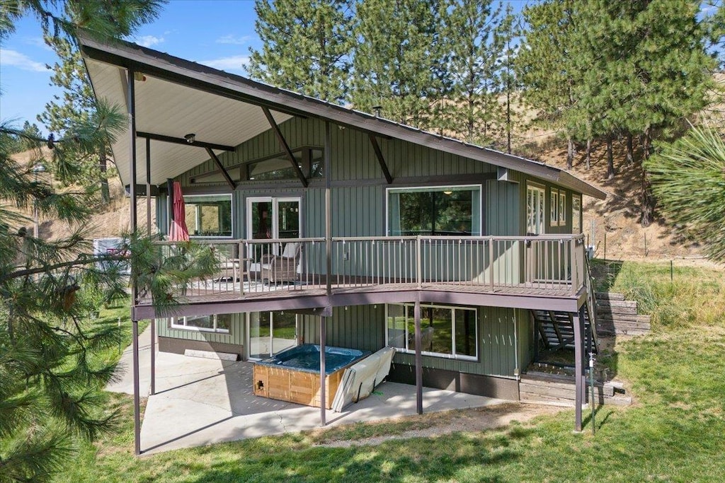 rear view of house with a deck and a patio area