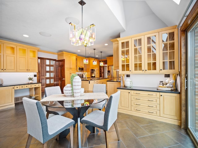 tiled dining space with a notable chandelier and lofted ceiling